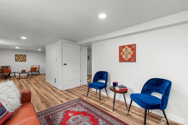 sitting room with recessed lighting, baseboards, and wood finished floors