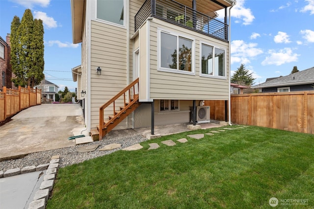 back of property with a patio area, a lawn, a fenced backyard, and ac unit