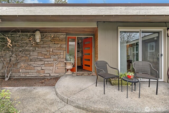 doorway to property with stone siding