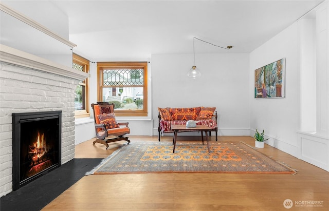 living area featuring a fireplace and wood finished floors