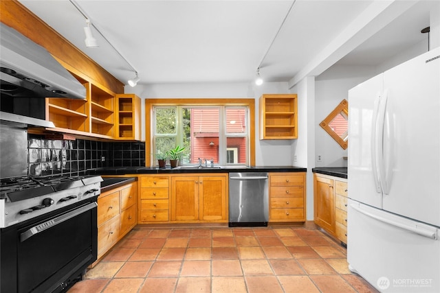 kitchen featuring dark countertops, open shelves, range with gas cooktop, freestanding refrigerator, and stainless steel dishwasher