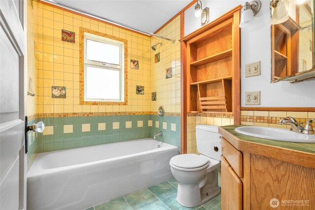 full bath featuring vanity, shower / tub combination, tile patterned flooring, tile walls, and toilet