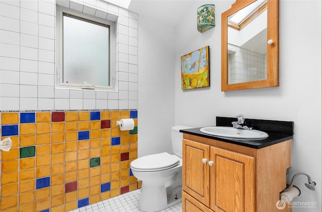 bathroom featuring vanity, tile patterned floors, and toilet