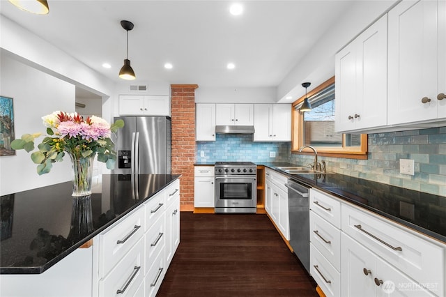 kitchen with visible vents, under cabinet range hood, dark wood finished floors, appliances with stainless steel finishes, and a sink