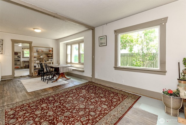 6845 S Clement Ave, Tacoma, WA 98409 - dining area with wood finished floors, baseboards, and a textured ceiling