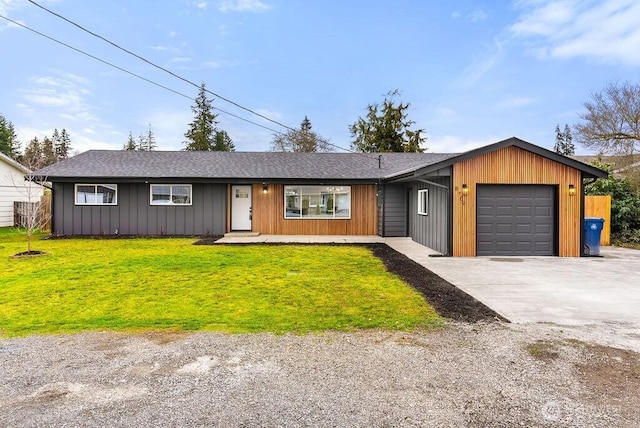 view of front of property featuring a front yard, roof with shingles, concrete driveway, and an attached garage