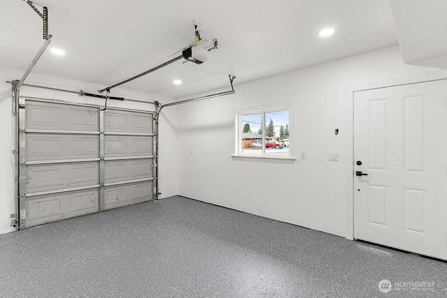 garage with recessed lighting and a garage door opener