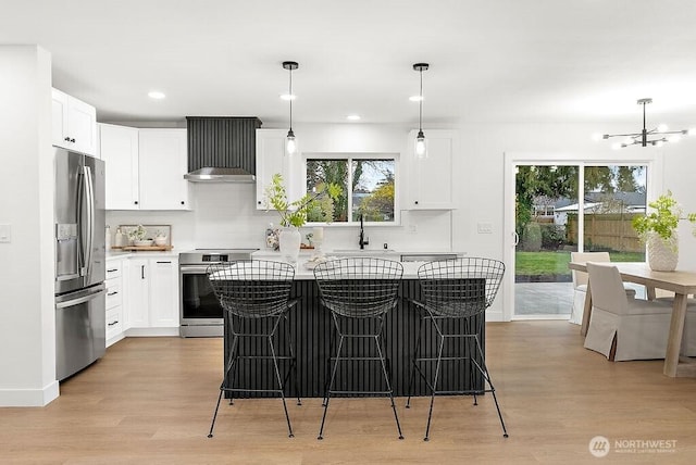 kitchen featuring a center island, stainless steel fridge with ice dispenser, light wood-type flooring, stove, and a sink