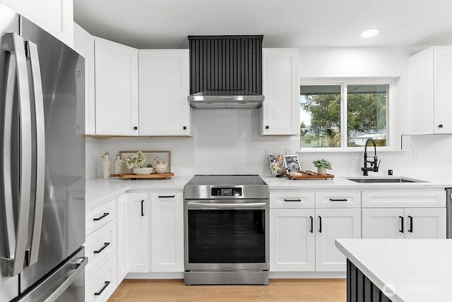 kitchen featuring light countertops, tasteful backsplash, appliances with stainless steel finishes, and a sink