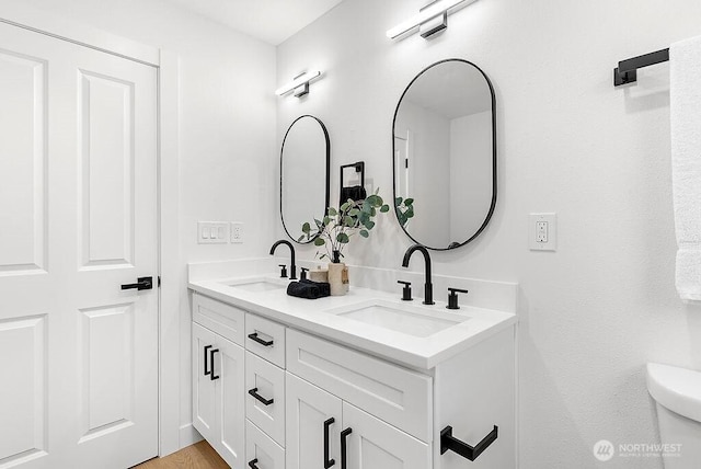 full bath featuring double vanity and a sink