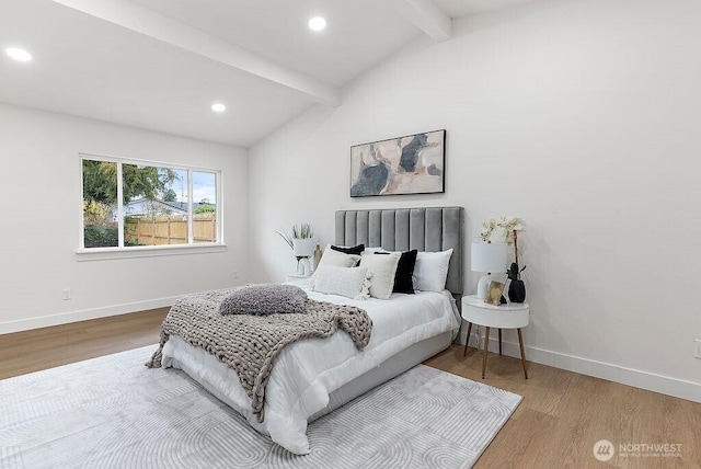 bedroom with recessed lighting, lofted ceiling with beams, baseboards, and wood finished floors