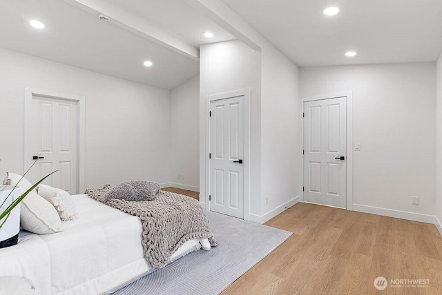 bedroom featuring recessed lighting, baseboards, light wood-style flooring, and vaulted ceiling with beams