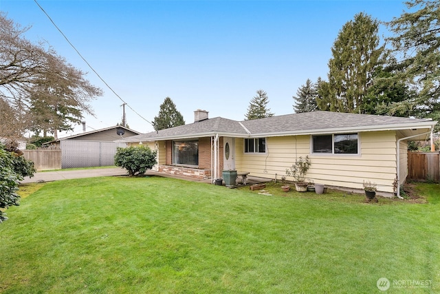 single story home featuring a front yard, fence, driveway, and a chimney