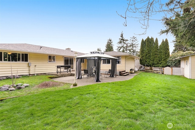 back of house with a gazebo, a patio area, a yard, and fence