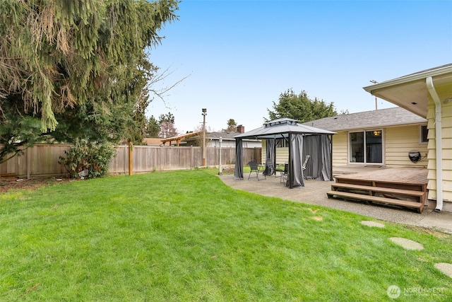 view of yard with a gazebo, a fenced backyard, and a patio