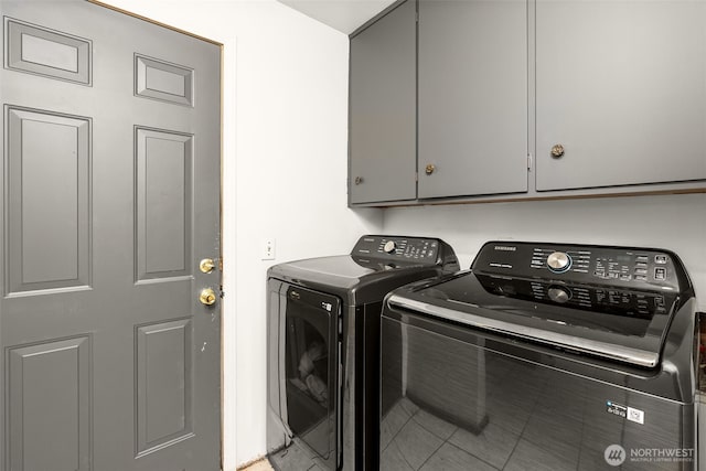 washroom featuring washer and dryer and cabinet space