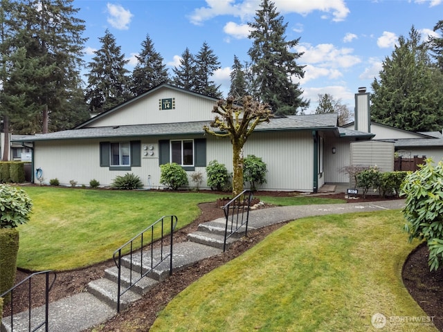 ranch-style house featuring a front lawn, fence, and a chimney