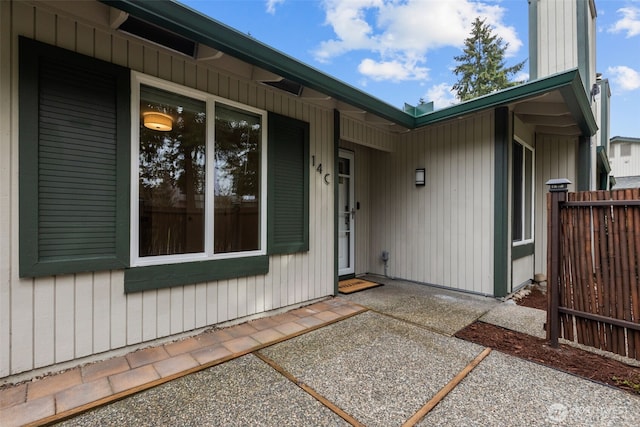 property entrance with a patio and fence