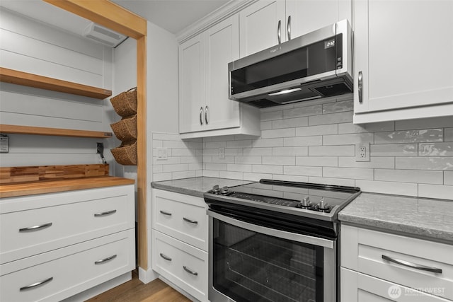 kitchen featuring white cabinetry, open shelves, backsplash, and appliances with stainless steel finishes