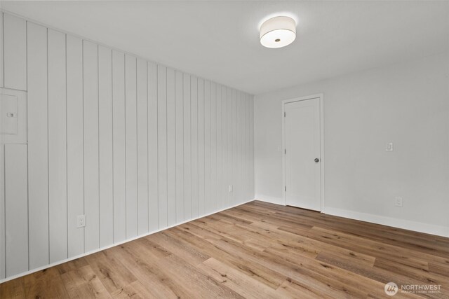 unfurnished room with wood finished floors