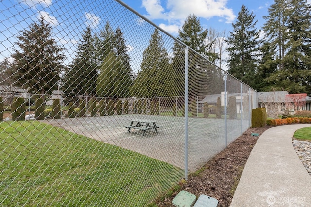 view of property's community featuring fence and a lawn