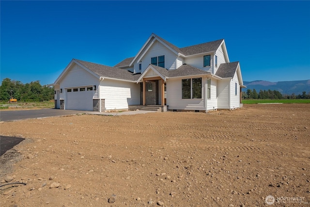 traditional home featuring an attached garage, a mountain view, driveway, and crawl space