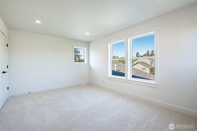 carpeted spare room featuring recessed lighting and baseboards