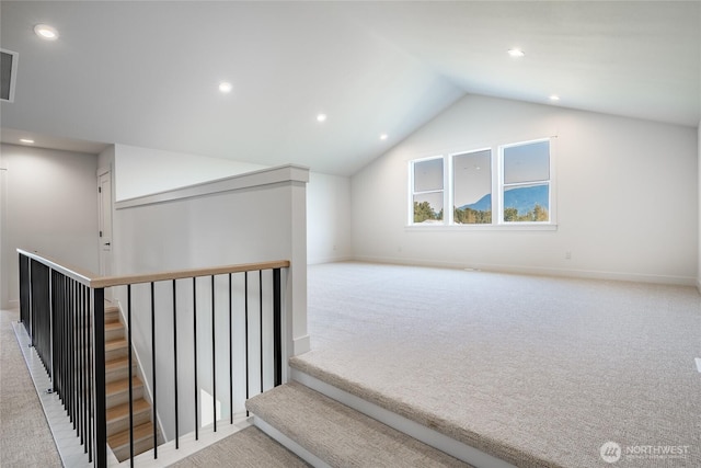 additional living space with baseboards, visible vents, recessed lighting, vaulted ceiling, and carpet flooring