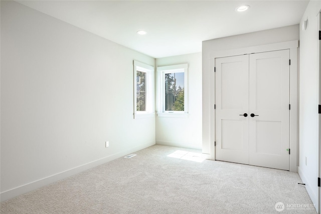 unfurnished bedroom with recessed lighting, baseboards, and carpet