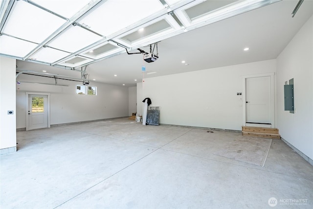 garage with electric panel and a garage door opener