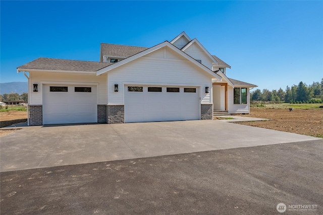 craftsman inspired home featuring concrete driveway and a garage