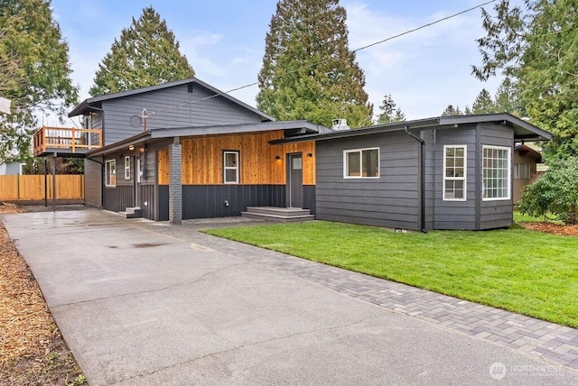 view of front of house featuring a front lawn and fence