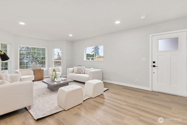 living room featuring recessed lighting, baseboards, and wood finished floors