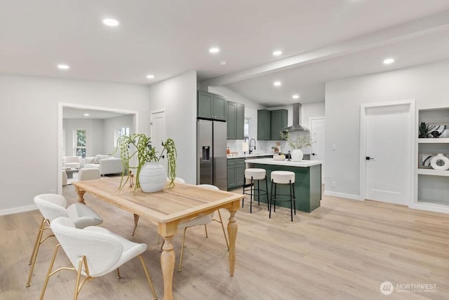 dining space with recessed lighting, light wood-type flooring, and baseboards