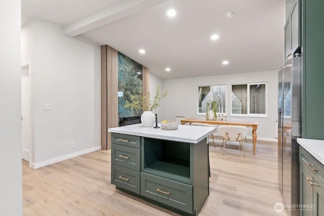 kitchen with green cabinetry, light wood-type flooring, recessed lighting, and light countertops