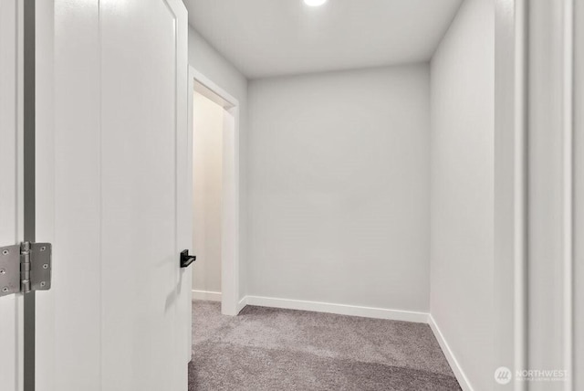 spare room with baseboards and carpet