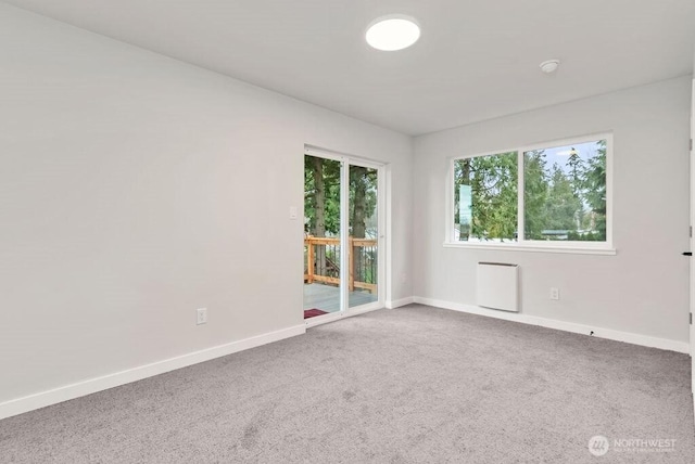 unfurnished room featuring baseboards and carpet flooring