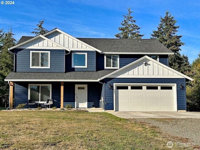 view of front of property with board and batten siding, a front yard, covered porch, a garage, and driveway