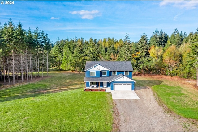 traditional home with an attached garage, board and batten siding, a front lawn, a view of trees, and driveway