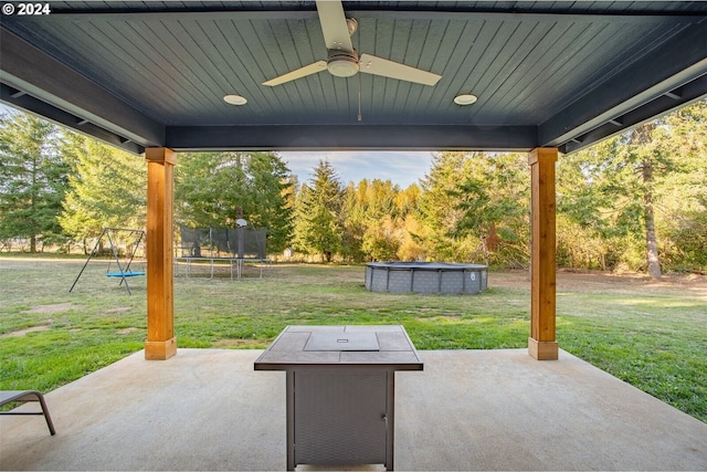 view of patio featuring a trampoline, a ceiling fan, and an outdoor pool