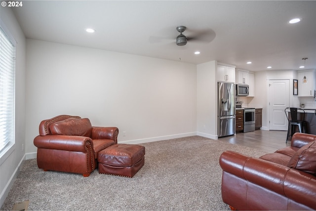 carpeted living area with a ceiling fan, recessed lighting, and baseboards