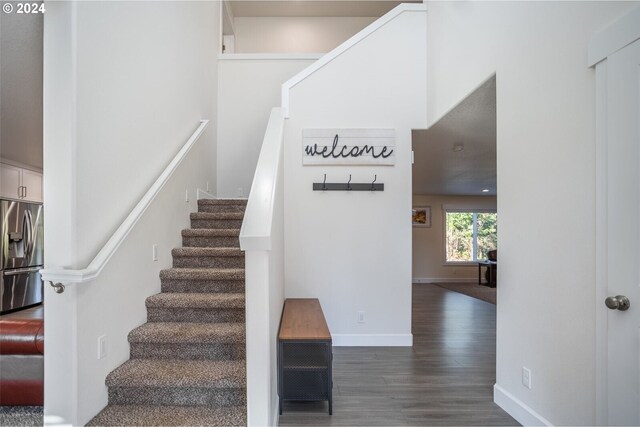 stairway with baseboards and wood finished floors