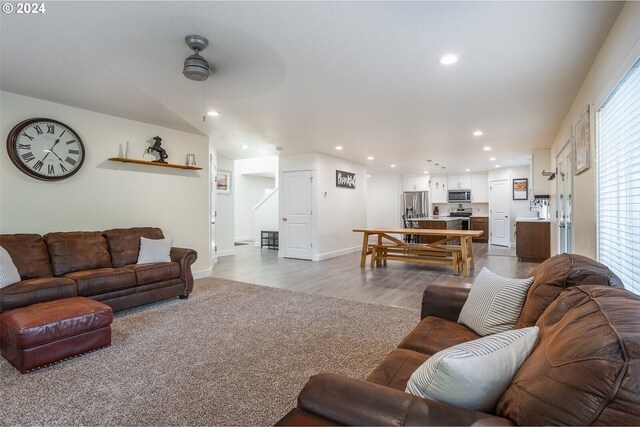 living area with recessed lighting, baseboards, a ceiling fan, and dark wood-style flooring