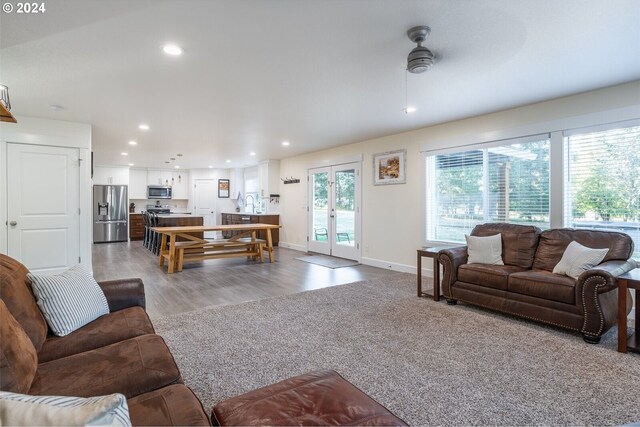 living room with recessed lighting, french doors, light wood-style floors, baseboards, and ceiling fan