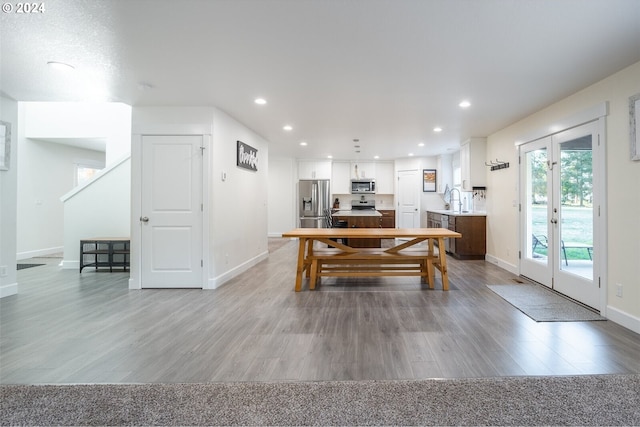 dining area with recessed lighting, french doors, baseboards, and light wood-style flooring