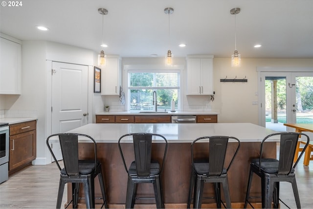 kitchen featuring dishwasher, french doors, a wealth of natural light, and a sink