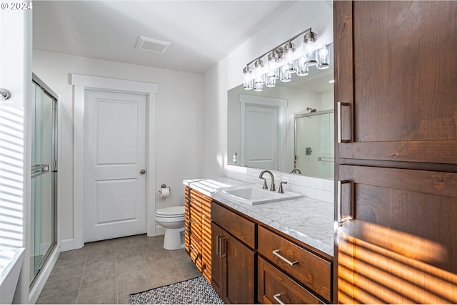 bathroom featuring vanity, visible vents, a stall shower, tile patterned flooring, and toilet