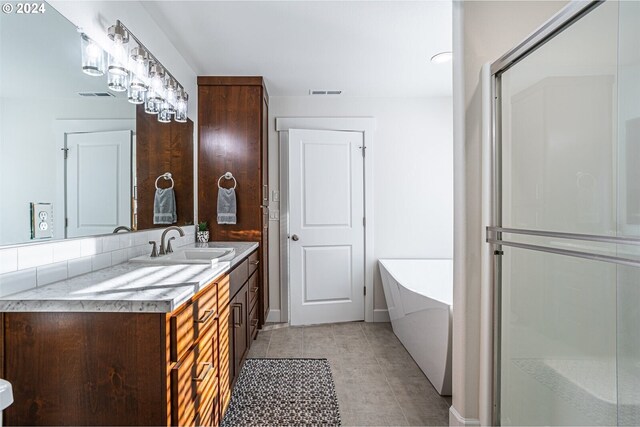 full bathroom with visible vents, a bathtub, vanity, and tile patterned flooring