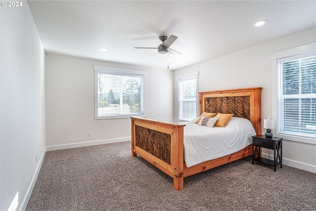 carpeted bedroom with ceiling fan, recessed lighting, baseboards, and a textured ceiling