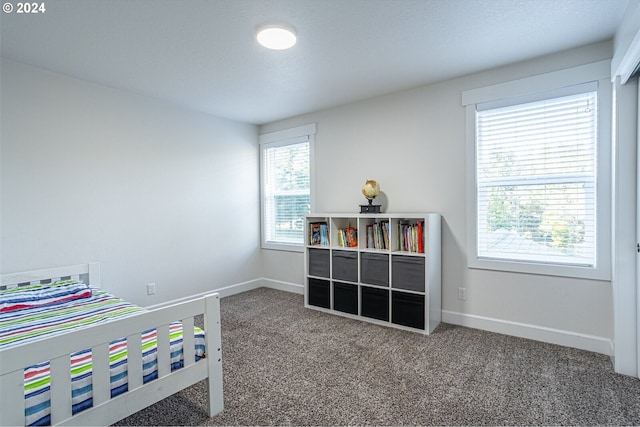 bedroom featuring carpet flooring and baseboards